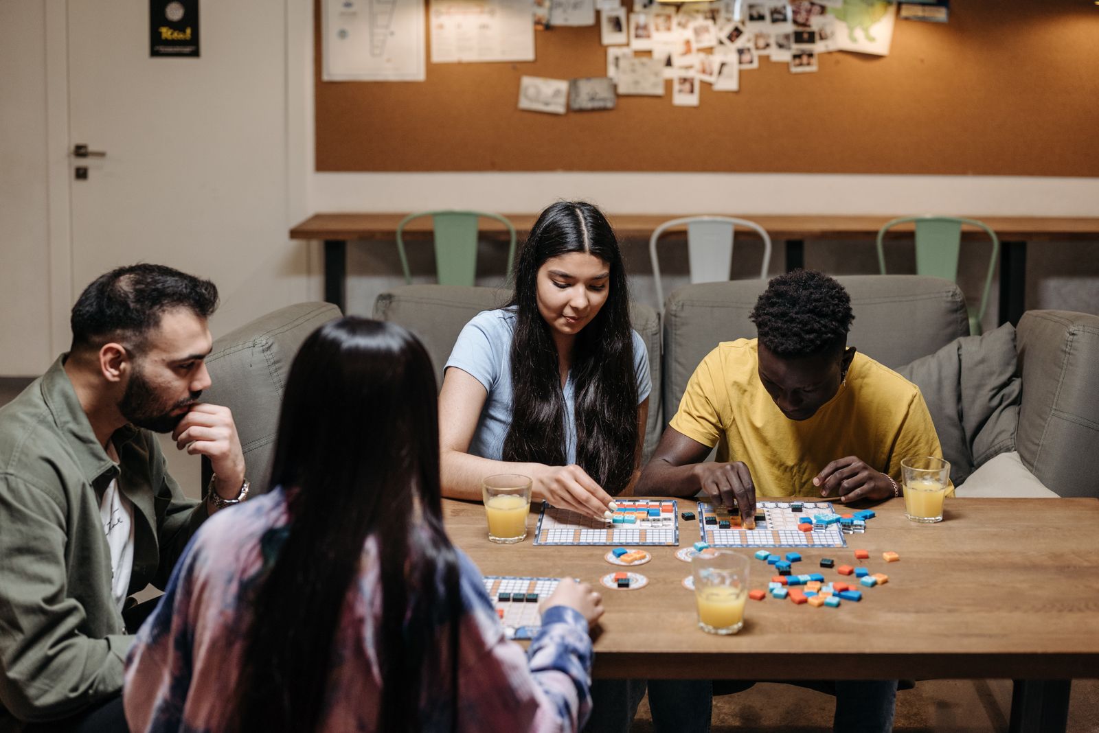 Friends gathered around a table playing a board game