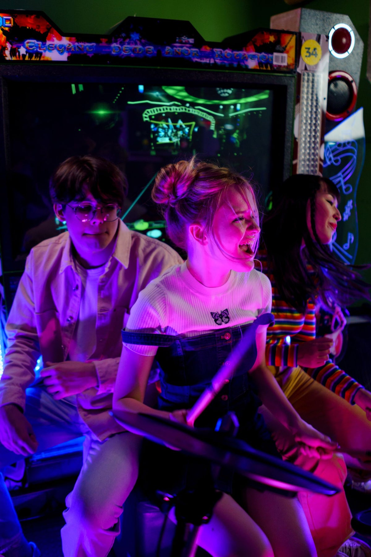 Friends enjoying a colorful neon arcade